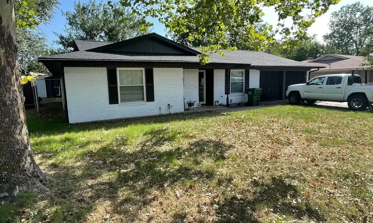 Professional roofing crew working on a residential roof in Marilla